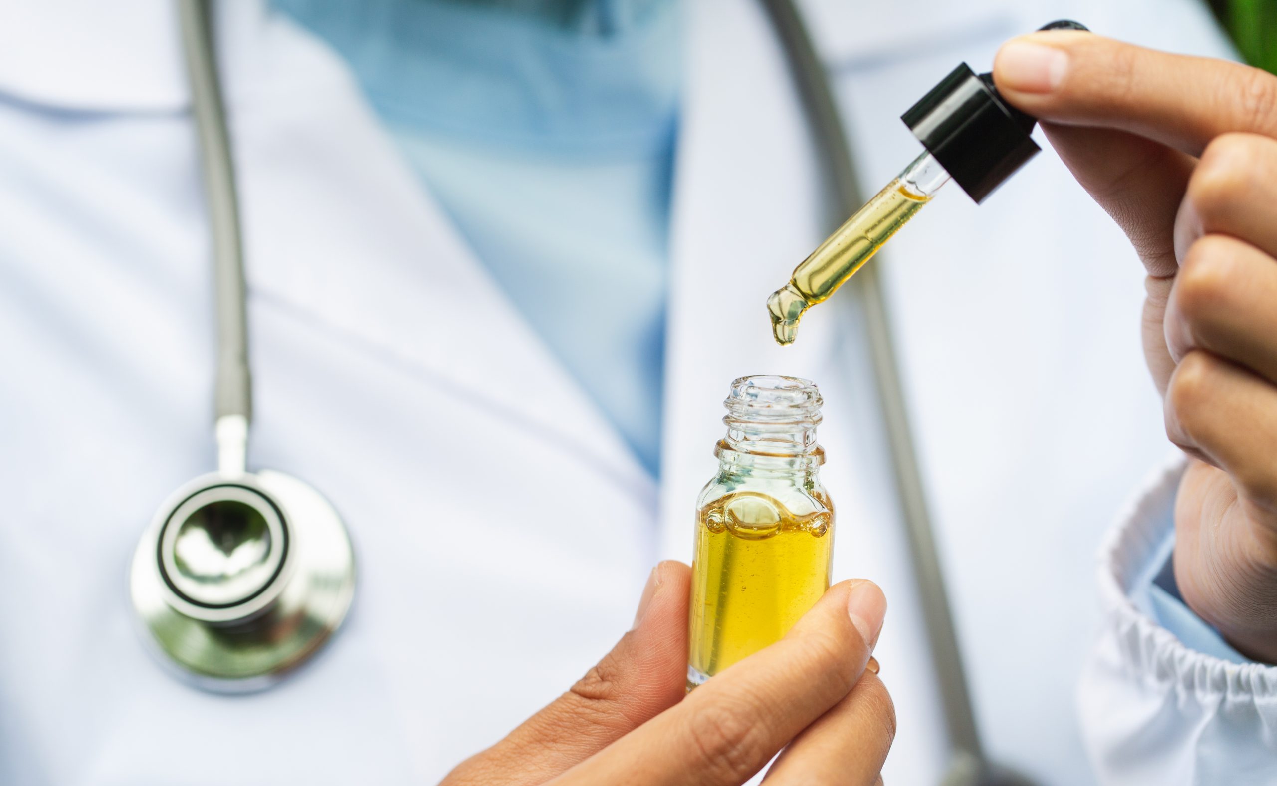 CBD Hemp oil, Doctor holding a bottle of hemp oil, Medical marijuana products including cannabis leaf, cbd and hash oil, alternative medicine CBD Hemp oil, Doctor holding a bottle of hemp oil, Medical marijuana products including cannabis leaf, cbd and hash oil, alternative medicine